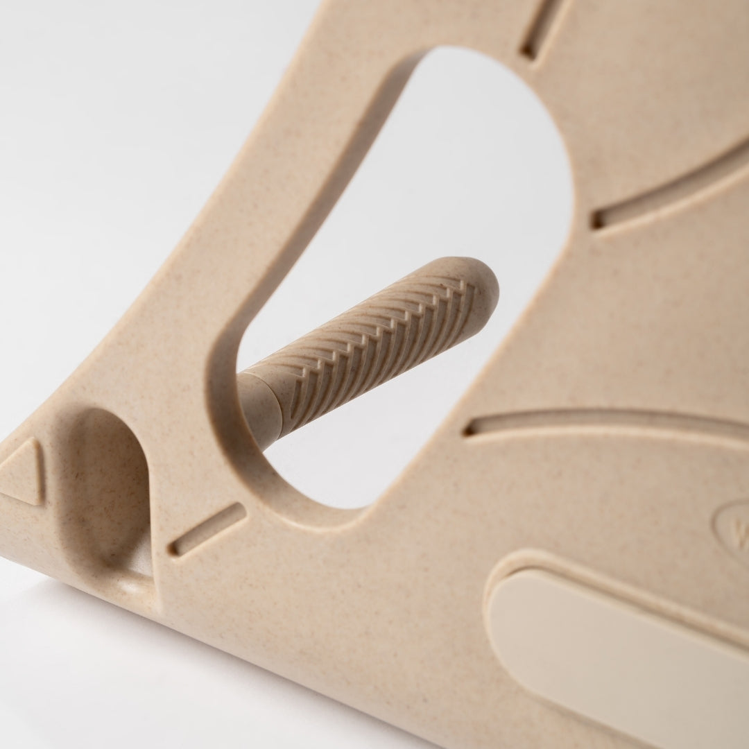 Beige Reliefboard massager with textured handle on a white background